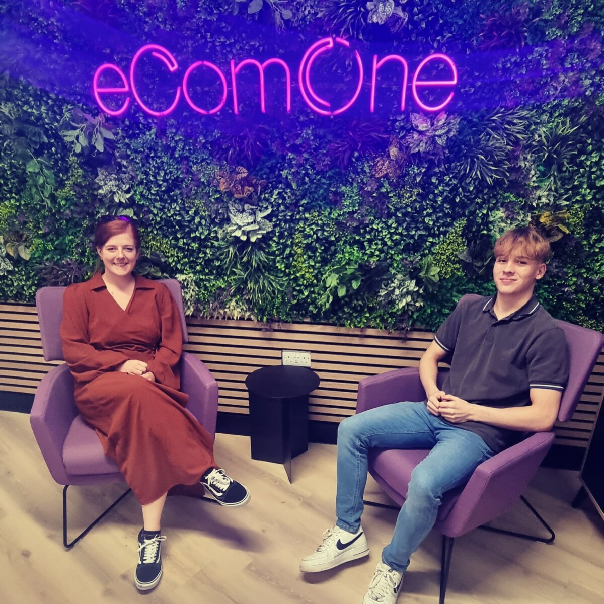 carrianne and travis infront of the ecomone sign