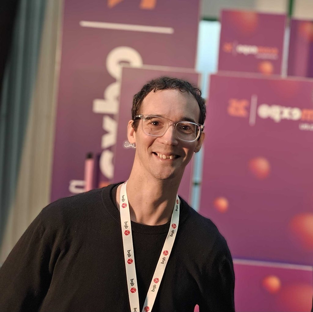 headshot of kieran wright at a speaking event in Lithuania