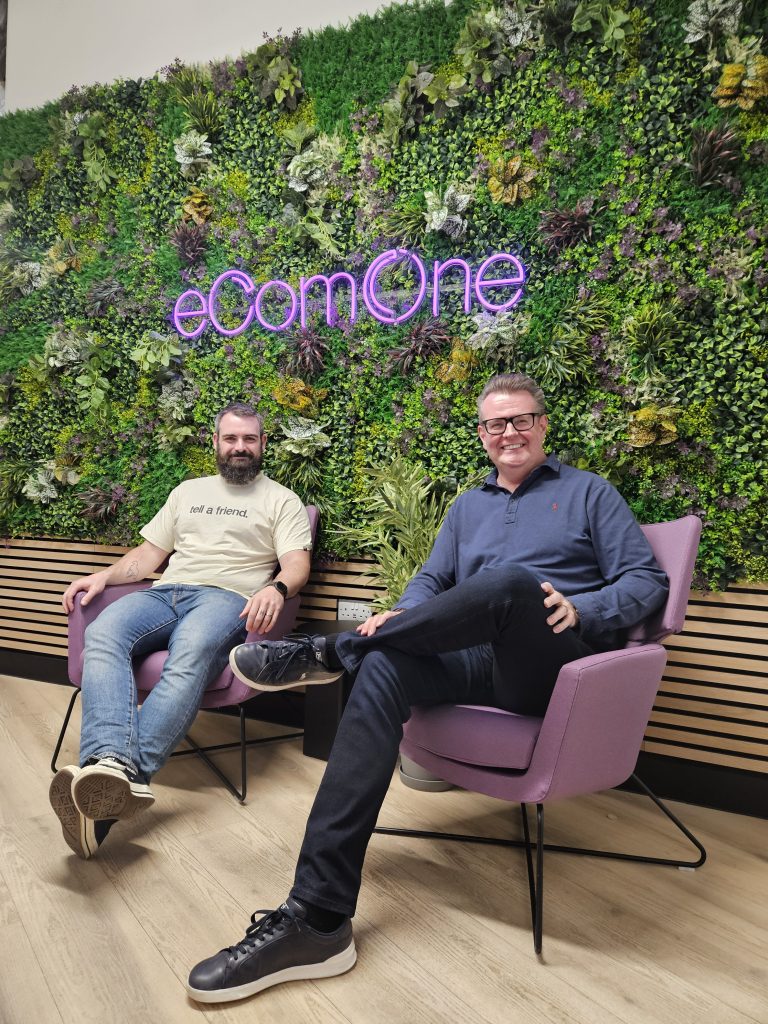 richard hill and stephen kenwright sat infront of the ecomone sign