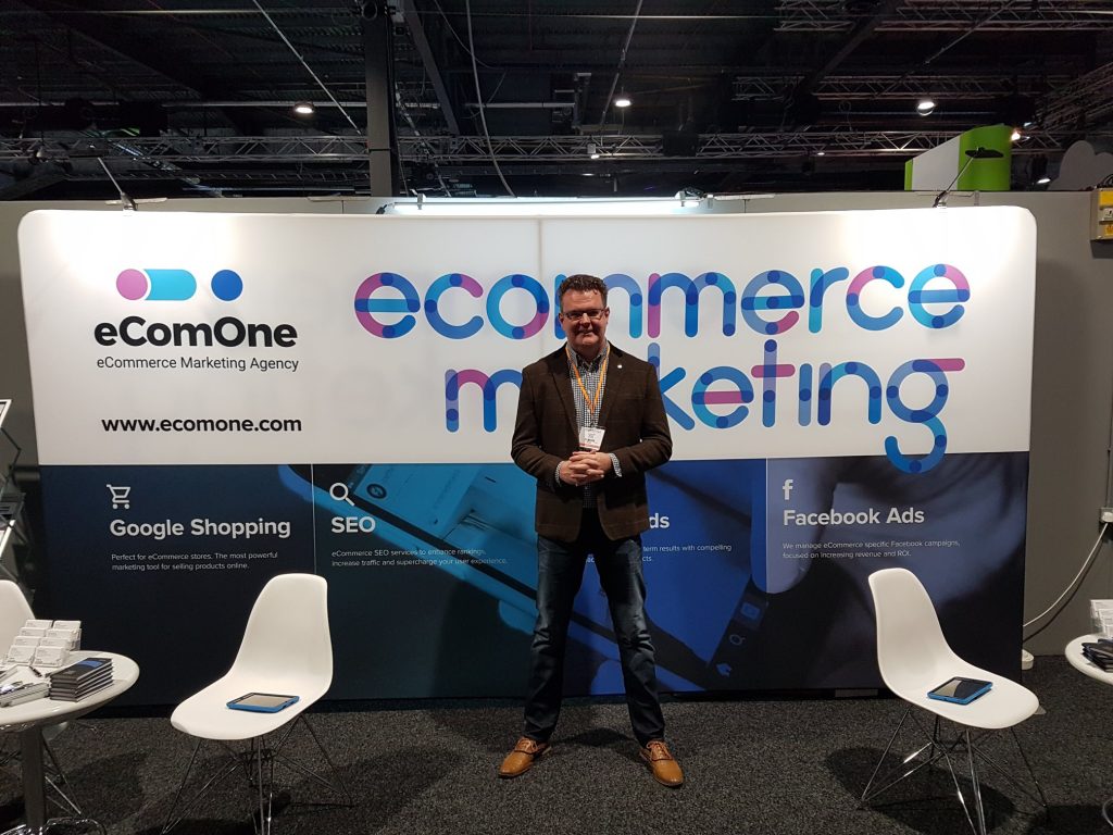 ecomone agency - richard standing in front of a stand at irx