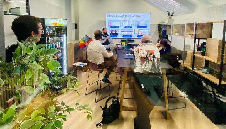 picture of people stood around the high table in the new ecomone office