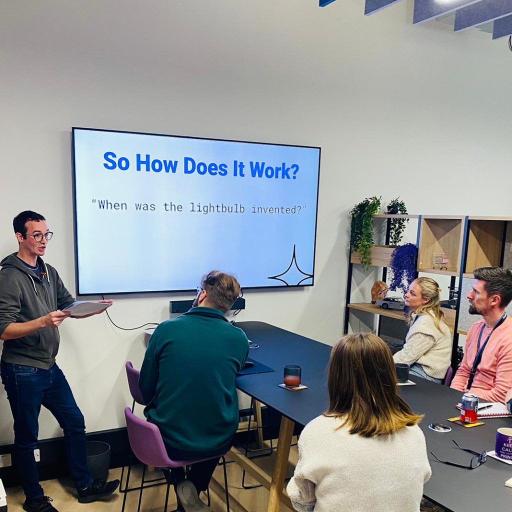 picture of kieran presenting to the team in the office