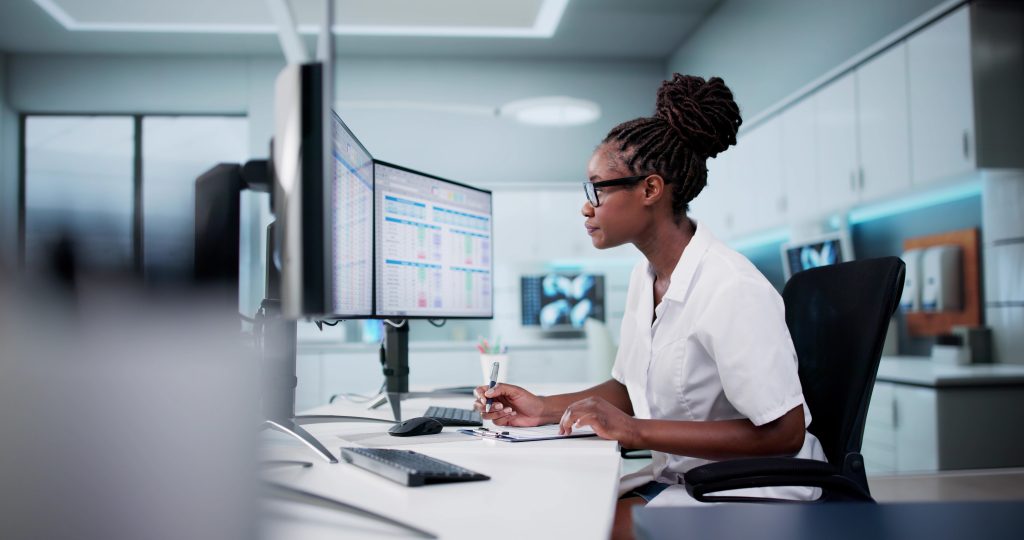 woman sat at a desk looking at the computer