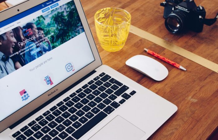 Picture of a laptop and drink with the screen showing Facebook Ads
