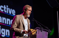 Person recording a podcast with microphone and headphones in a studio setup