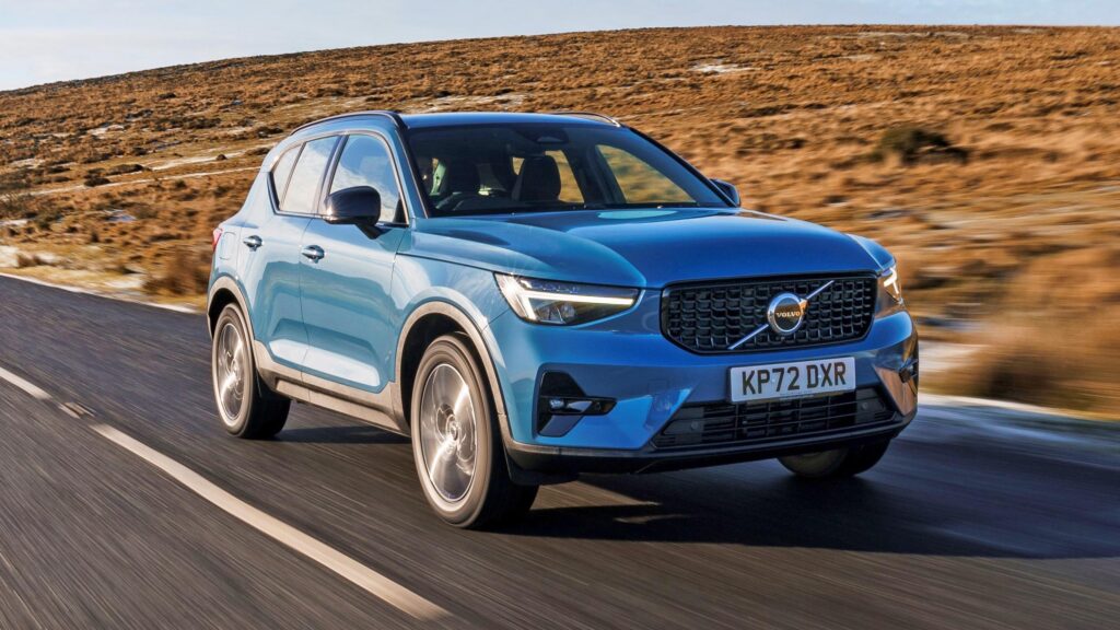 picture of a blue volvo car on a road